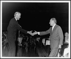 Hoagy Carmichael shaking hands with James Stewart at an Indiana University Alumni Association event honoring Carmichael, Hollywood.