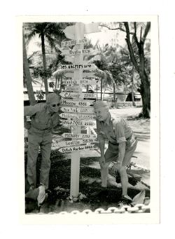 Roy Howard poses by travel signs