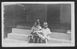 Young Martha and Joanne Carmichael sitting on front porch, summer 1918.