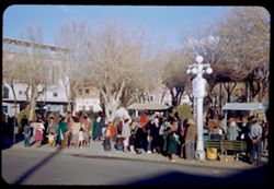 Women and children waiting for Bus at corner of plaza.  Juarez.