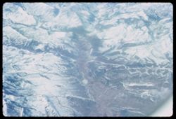 Snow-covered Rocky mountains below Pan-Am jet London bound from Los Angeles.
