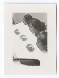 Item 0860. - 0866. Various shots of three Indigenous women seated by coffin.