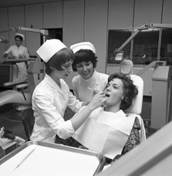 Students with patient in IU South Bend dental clinic, 1970s