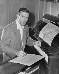 Hoagy Carmichael composing at his piano.