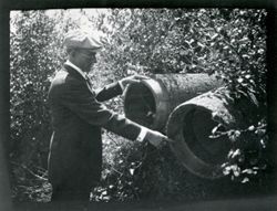 Man with barrels or wooden pipes