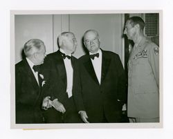 Roy Howard, Herbert Hoover, and other men talking