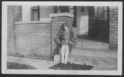 Martha Carmichael seated on the front porch at 3037 Graceland Avenue, Indianapolis, Indiana, winter 1930.