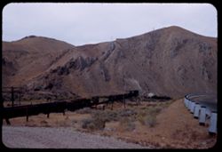 Southern Pacific westbound freight 20 miles west of Elko, Nevada, disappears into tunnel.