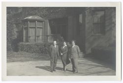 Item 56. Unidentified man and woman standing with Eisenstein (right) in front of large house partially covered with ivy.