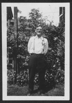 Howard Carmichael standing in front of garden, ca. 1940.