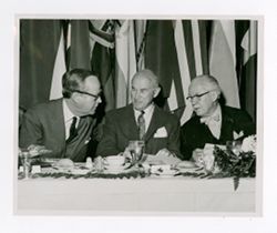 Roy Howard and other men at a table