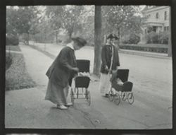 Two girls with doll carriages