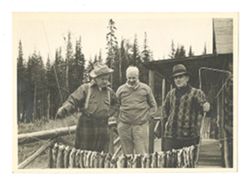 Roy Howard and others posing with fish