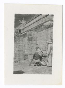Item 1020. - 1022. Eisenstein and another man with head under camera cloth filming at corner of Temple of the Warriors, with colonnade in background.