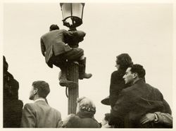 Man on lamp post in Paris