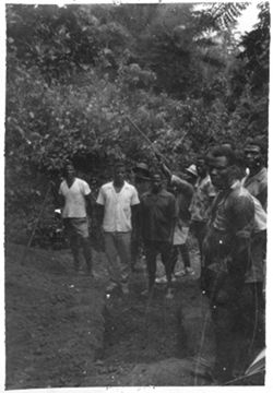 Sons of ex-speaker of Sabo standing beside grave