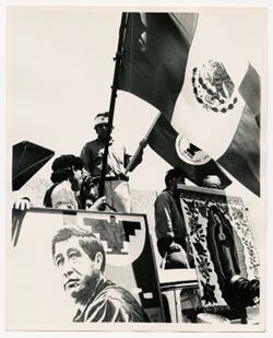 Supporters holding flags and photographs of Cesar Chavez