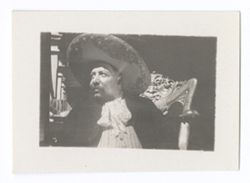 Item 0913. - 0913a. Similar shots of elderly man wearing sombrero and lace-front shirt seated in ornate wooden chair. Same man is seen in Item 218 above, seated, center, on the veranda to "Maria" left.