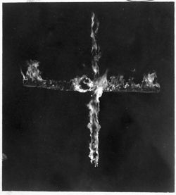 A fiery cross, photographed on a hillside north of town when the Ku Klux Klan held sway