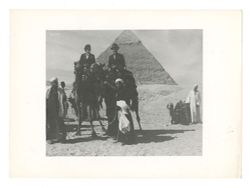 Roy Howard (?) and companion on camels