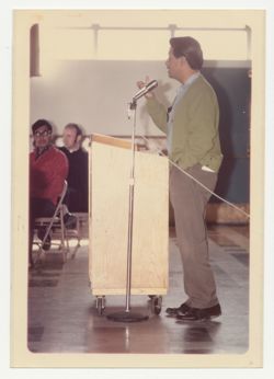 Cesar Chavez speaking into microphone