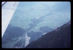 X A mountain ridge and green valley below plane between Salzburg and Innsbruck.