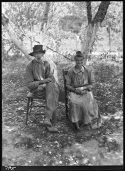 Alex Mullis and wife, Mandy (Fleetwood) Mullis seated under cottonwood tree