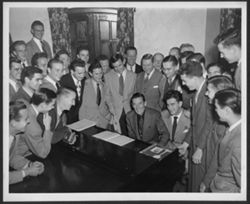 Hoagy Carmichael at piano, surrounded by Kappa Sigma brothers.