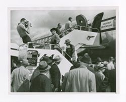 Roy Howard and other men boarding a plane
