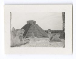 Item 0647. - 0648. Taken from upper level of Temple, with stone serpent's head and Chac-Mool in foreground.
