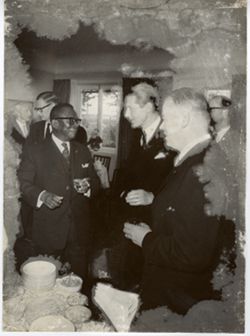President William V. S. Tubman stands and talks with two others