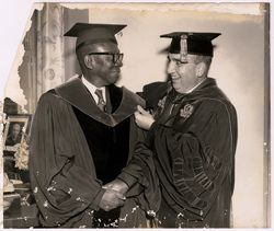 Dr. Peter Sammartino adjusts President William V. S. Tubman's doctoral hood