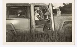 Mrs. Antoinette Tubman sits in a truck within a field