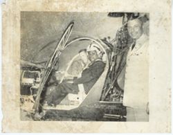 Men pose inside and next to helicopter