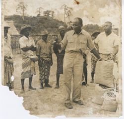Man stands with Firestone bags surrounded by people
