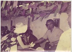 President Tubman and woman greet one another in outdoor reception area