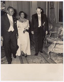 President William V. S. Tubman and Mrs. Tubman walk with a dignitary
