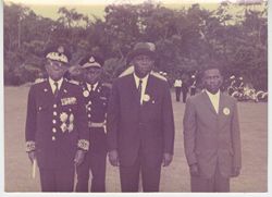 A uniformed President Tubman and companions pose for portrait