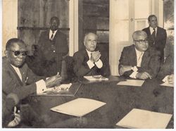 President Tubman seated at end of conference table