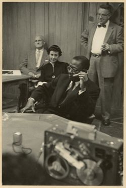 President William V. S. Tubman sits during press confeence, others surrounding