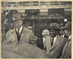President William V. S. Tubman and others walk and laugh together