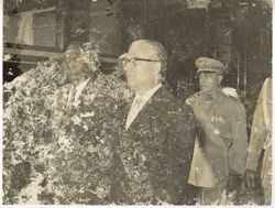 President William V. S. Tubman walk with officials past a train