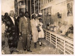 President William V. S. Tubman and Mrs. Tubman viewing objects behind glass