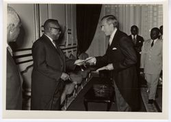 President William V. S. Tubman greets official at formal event