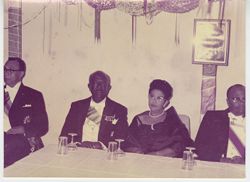 Guests in formal attire seated at reception table