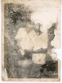 Two men with a bucket