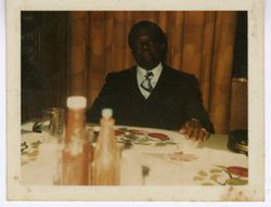 Man in business attire seated at dinner table