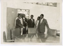 President William V. S. Tubman enters meeting room with officials