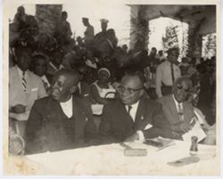 Men at table sit in audience