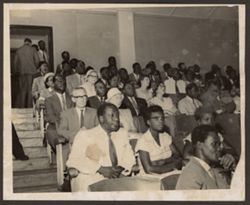 A crowd sits in an auditorium